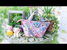 a purse sitting on top of a table next to potted plants