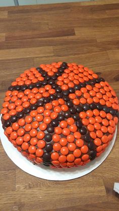 a cake decorated with orange and black candies