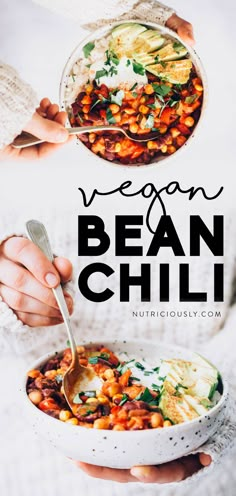 vegan bean chili in a white bowl with spoons and hands holding the bowl