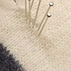 three pins are stuck in the carpet with one on it's side and another on its side