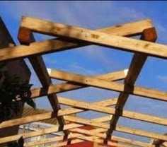 a man riding a skateboard on top of a wooden structure