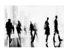 black and white photograph of people walking down the street