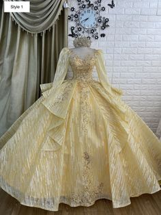 a yellow dress is on display in front of a clock