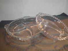 two clear glass dishes sitting on top of a table