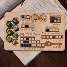 a wooden board game set with dices and numbers on top of it next to some books