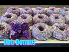 there are many donuts with purple frosting on them