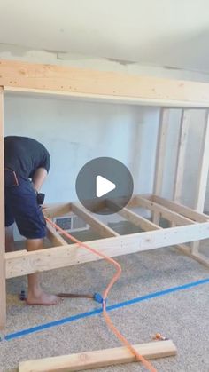 a man is working on an unfinished bed frame