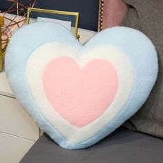 a heart shaped pillow sitting on top of a table