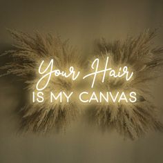 the words your hair is my canvas are lit up in front of some fluffy feathers