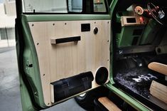 the interior of an old green truck with wood trim