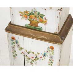 an old painted cabinet with flowers on it