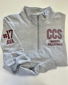 two sweatshirts with the words ccs and varsity volleyball on them are sitting next to each other