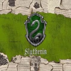 the slytherin logo on top of an old book page with torn up pages