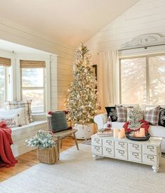 a living room with a christmas tree in the corner