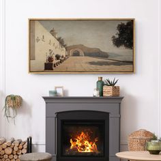 a living room with a fire place in the center and paintings on the wall above it