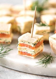 small appetizers with toothpicks in them sitting on a plate next to other snacks