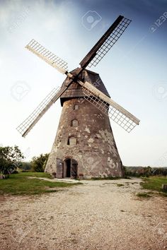 an old windmill on a dirt road in the countryside stock photo - 959782