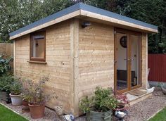 a small wooden shed sitting in the middle of a yard