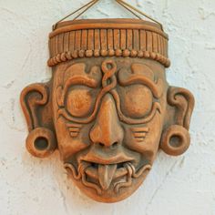 a mask hanging on the side of a wall