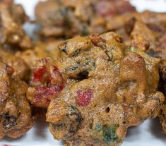 some food is on a white plate with red and green trim around the edges that are smothered in powdered sugar