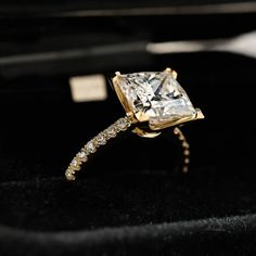 an engagement ring with a princess cut diamond