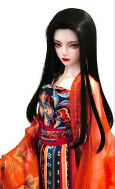 a doll with long black hair wearing an orange kimono