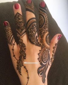 a woman's hand with henna tattoos on it