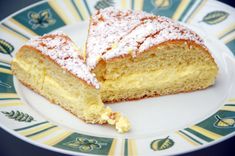 there is a piece of cake on the plate with powdered sugar and icing