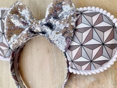 Epcot Spaceship Earth ears. Classic Epcot ball fabric outlined with white trim and a silver sequin bow. Handmade and durable, perfect for a day in the parks. Please email any questions. Thanks for checking out our shop!