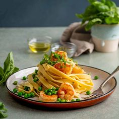 pasta with shrimp and peas on a plate