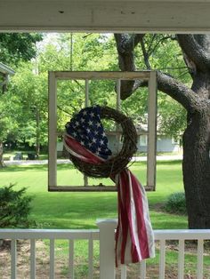 an american flag wreath hanging on the front porch