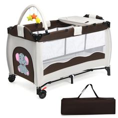 the baby crib has an elephant design on it and is next to a bag