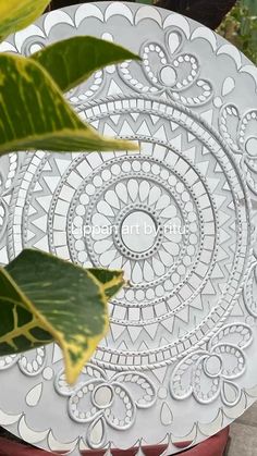 a white plate sitting on top of a table next to a plant