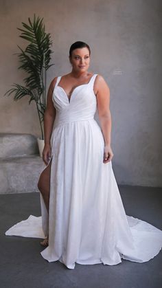 a woman in a white dress posing for the camera