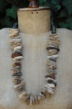 a necklace made out of rocks on top of a mannequin