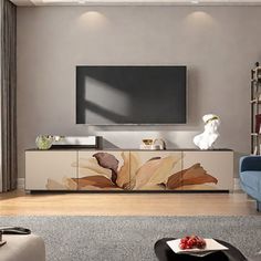 a living room with a large television on the wall and furniture in front of it