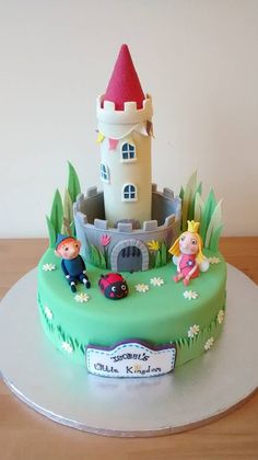 there is a cake that looks like it has a castle in the middle and people on top