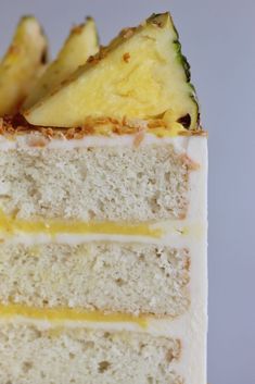 there is a piece of cake with pineapples on top and white frosting