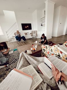 several people sitting on the floor reading books