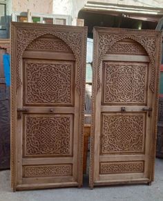 two carved wooden doors sitting next to each other