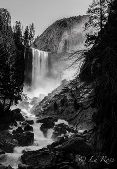 black and white photograph of waterfall in the mountains