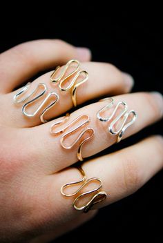 The elegant curves of this design are wave-like, creating a sense of movement and fluidity that is versatile and organic. The ring is handcrafted out of a D-shaped (half round) wire that is then flattened and formed into this three dimensional form. This listing is for ONE single ring in 14K Rose Gold Fill The thickness of the metal used with this ring measures approximately 2mm which gives this piece a durable and sturdy design while maintaining that effortless look. While this ring is gorgeous Elegant 14k Gold Wire Wrapped Rings, Minimalist Rose Gold Spiral Jewelry, Adjustable Wavy Rings With A Modern Twist, Elegant Adjustable Spiral Midi Rings, Modern Twist Rose Gold Ring, Elegant Gold Spiral Stackable Rings, Rose Gold Stackable Rings With Modern Twist, Rose Gold Stackable Open Rings With A Modern Twist, Modern Twist 14k Rose Gold Jewelry