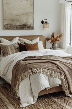 a large bed sitting in a bedroom next to a window