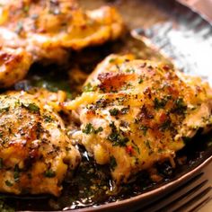 some chicken is cooking in a pan on the table