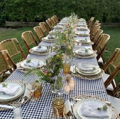 a long table set with place settings and plates