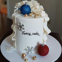 a fancy cake decorated with ornaments on a white platter for someone's special occasion