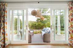 an open living room with two couches and large sliding glass doors that lead out to the back yard