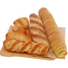 some breads and pastries are sitting on a piece of paper