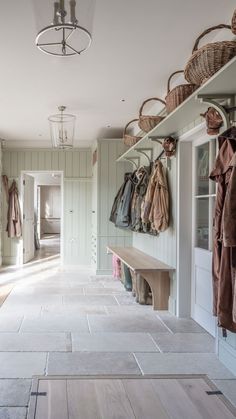 an image of a hallway with coats hanging on the wall