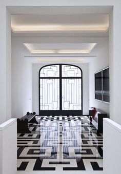 a black and white floor with an arched window in the center is decorated with geometric designs